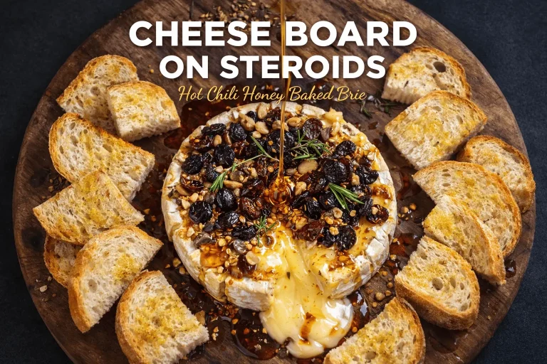 A wooden cheese board featuring a round of baked brie topped with dark berries, chopped nuts, and rosemary. Hot chili honey is being drizzled over the melting cheese, which is surrounded by toasted bread slices. Large white text at the top reads "CHEESE BOARD ON STEROIDS," with smaller gold text below saying "Hot Chili Honey Baked Brie.