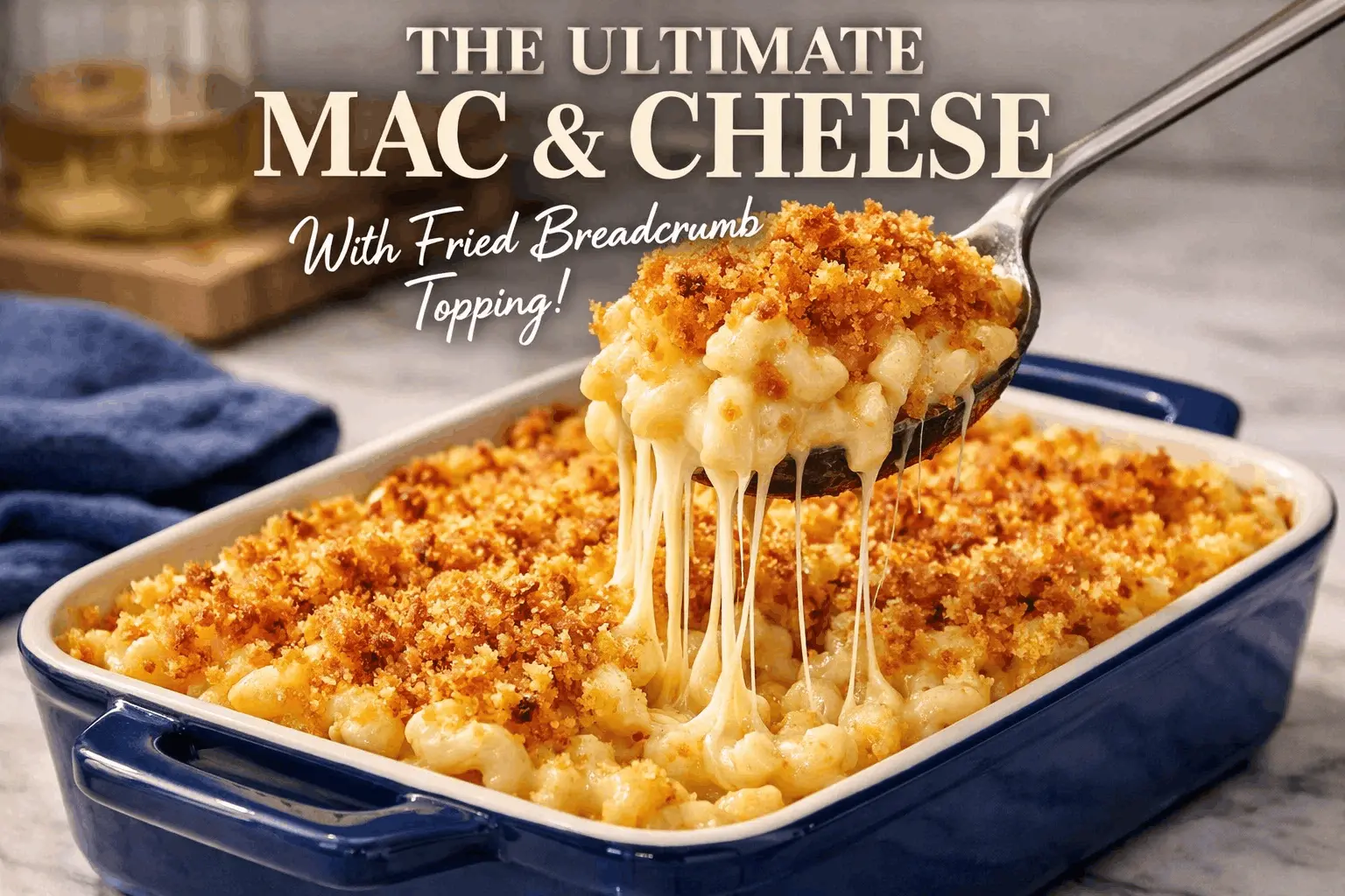 A blue rectangular baking dish filled with creamy macaroni and cheese topped with a thick layer of golden-brown fried breadcrumbs. A silver spoon lifts a large scoop from the dish, creating long, gooey strands of melted cheese. Large white text at the top reads "THE ULTIMATE MAC & CHEESE," with "With Fried Breadcrumb Topping!" written in white script below it.