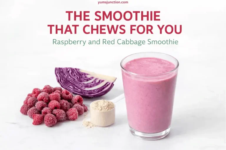 A promotional graphic for a "Raspberry and Red Cabbage Smoothie" shown against a white marble background. It features the pink smoothie in a glass next to a pile of frozen raspberries, a wedge of raw red cabbage, and a scoop of tan protein powder. Bold red text at the top reads "THE SMOOTHIE THAT CHEWS FOR YOU," with the website "yumsjunction.com" at the very top.