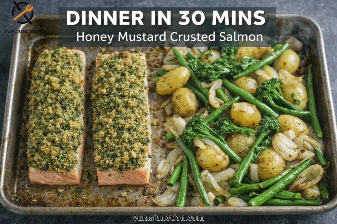 A horizontal food graphic with a dark grey banner at the top reading "DINNER IN 30 MINS" and "Honey Mustard Crusted Salmon" in white. The photo shows a well-used metal baking sheet fresh out of the oven. On the left are two salmon fillets with a thick, golden-green herb crust. On the right half of the pan is a colorful mix of roasted baby potatoes, green beans, broccolini, and sliced onions. The Yum Junction logo is in the top left, and the website URL "yumsjunction.com" is at the bottom center.