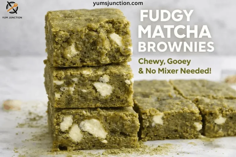 A horizontal food graphic for a recipe website. On the left, three thick, square-cut matcha brownies are stacked vertically, showcasing a dense, fudgy interior and melted white chocolate chunks. More brownie squares sit in the background on a marble surface. To the right of the stack, large white text reads "FUDGY MATCHA BROWNIES." Underneath, smaller green text says "Chewy, Gooey & No Mixer Needed!" The Yum Junction logo is in the top left, and the URL "yumsjunction.com" is at the top center.