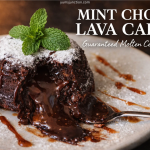 A professional food graphic for "MINT CHOC LAVA CAKE." The image shows a dark chocolate lava cake on a speckled white plate, dusted with powdered sugar and topped with a fresh mint sprig. The cake is broken open, revealing a rich, molten chocolate center flowing out onto the plate. A silver spoon is digging into the molten chocolate, and the plate is decorated with drizzles of caramel sauce. The Yum Junction logo and website address are at the top.