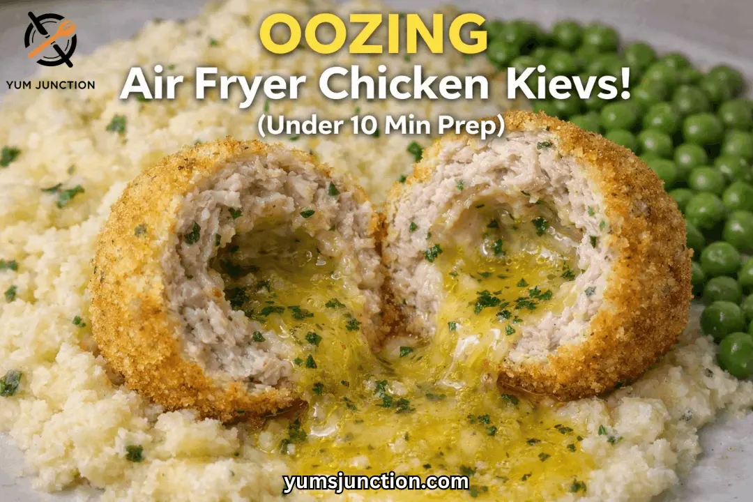 Promotional food graphic titled "OOZING Air Fryer Chicken Kievs!" with "Under 10 Min Prep" in text. The image is an extreme close-up of a breaded chicken ball split in two, with a stream of hot, melted yellow herb butter pouring out onto a bed of mashed potatoes. The Yum Junction logo and website URL are clearly visible.
