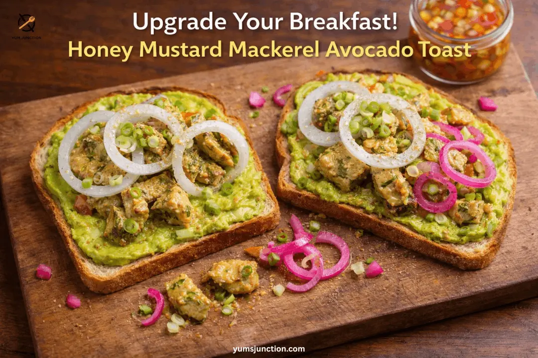 Two slices of mackerel avocado toast on a wooden board served with pickled red onions and a side of chili oil.