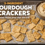 Crispy golden sourdough crackers on parchment paper with a side of hummus. Text overlay: "3-Ingredient Sourdough Crackers - Never throw away your discard!".