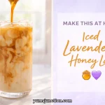 A horizontal promotional graphic titled "MAKE THIS AT HOME: Iced Lavender Honey Latte." The left side features a photo of dark espresso being poured into a tall, ribbed glass filled with milk and ice, creating creamy swirls. The right side contains the recipe title in orange script with a honey pot icon and a purple heart icon.