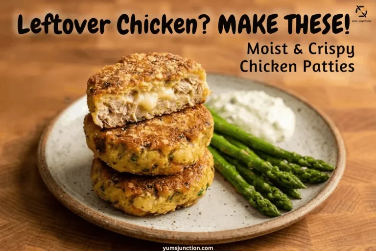 A horizontal promotional graphic featuring a stack of three crispy chicken patties. The top patty is broken open to reveal a juicy, moist interior with melted cheese. The dish is garnished with roasted asparagus and sauce on a rustic wooden surface. Includes the brand name Yum Junction and the URL.